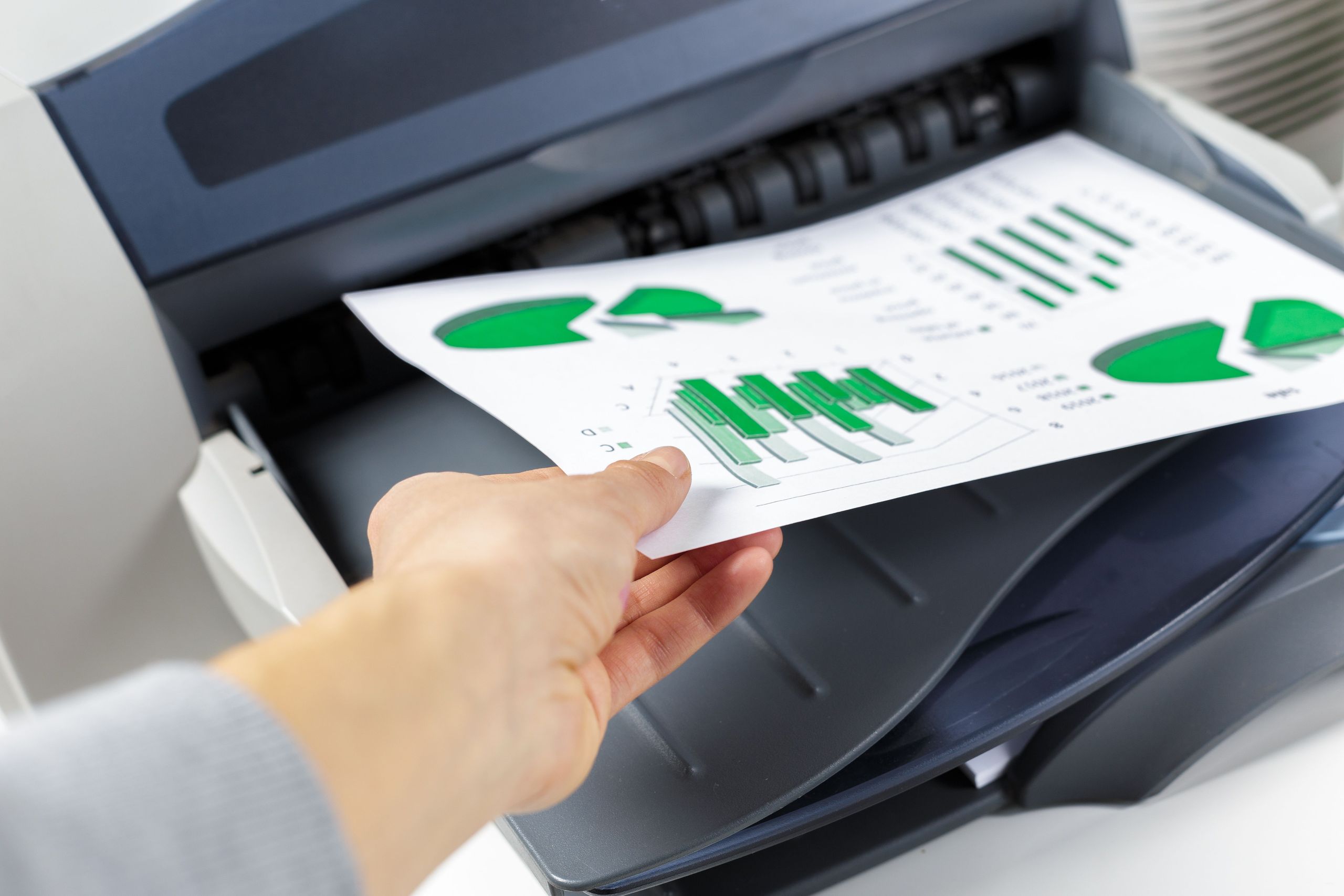 Office printer setup with eco-friendly elements reflecting sustainability and reduced paper usage through managed print services.